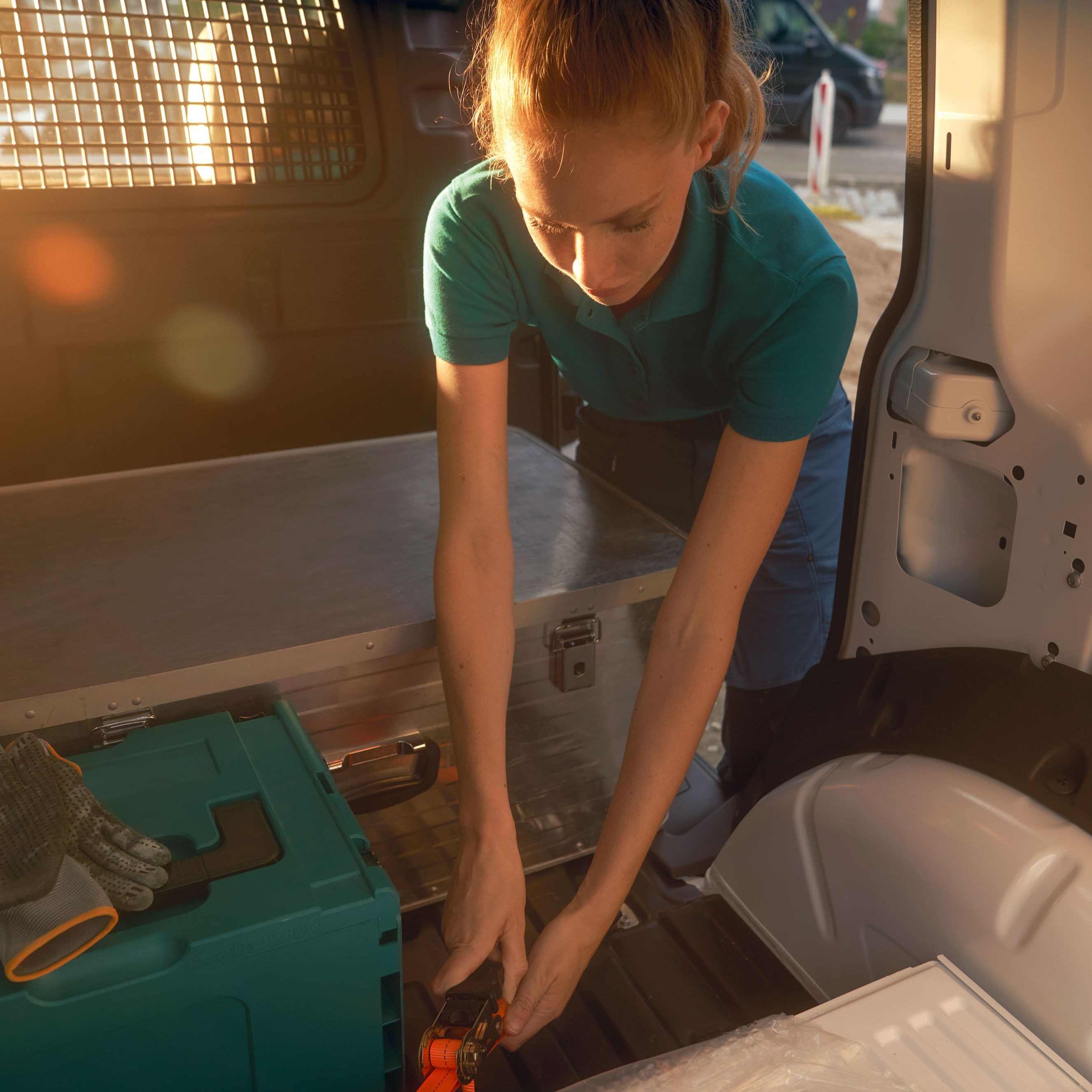 Жена по време на товарене на бял VW Caddy Cargo.