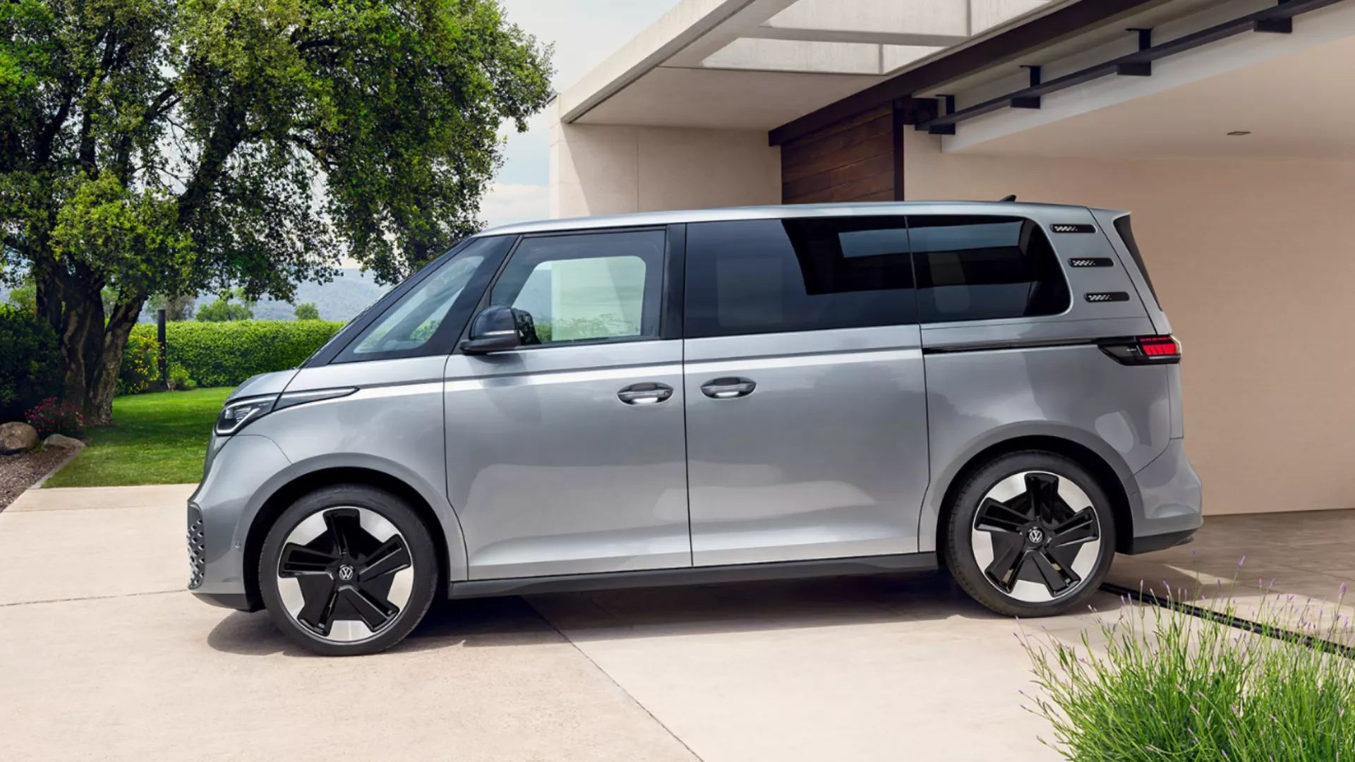 Seitenansicht silberner ID. Buzz, parkt in Hauseinfahrt